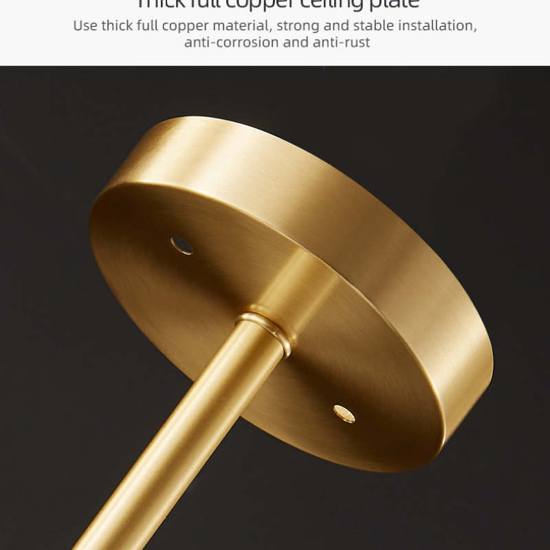 Kristy close-up of the round gold-tone ceiling plate and slim stem, with a caption describing a copper ceiling plate.