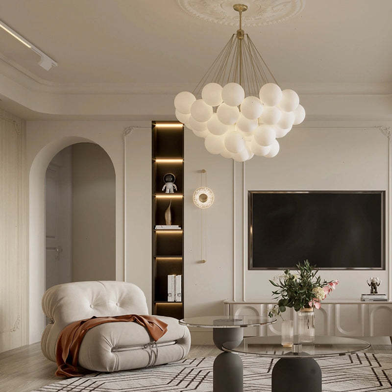 Gold suspension lines and white globes in a living room