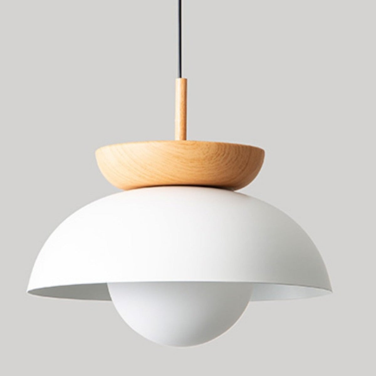 Close unlit white pendant dome, wood crown and sleeve, black cord and rounded white globe below the rim