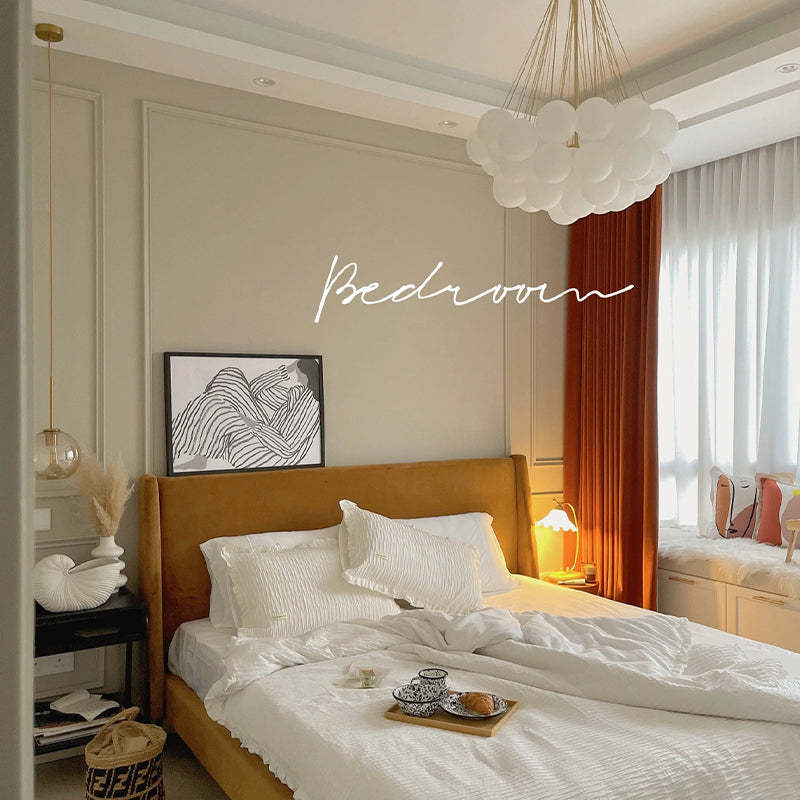 Gold globe pendant above a bed