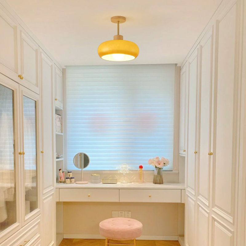 Orange Hailie dome light over a small dressing table by a window