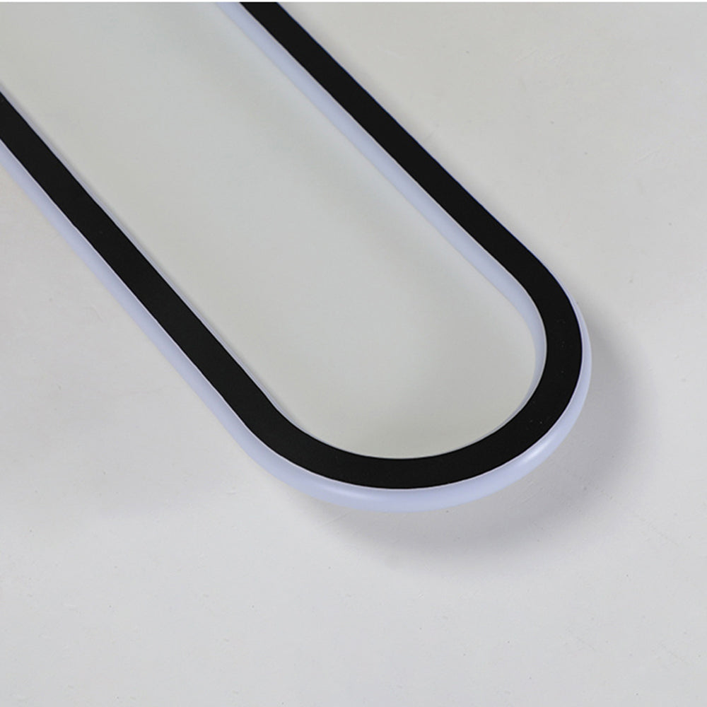 Unlit-looking Black Quinn rounded-end detail showing white outer border and pale centre against a plain ceiling.