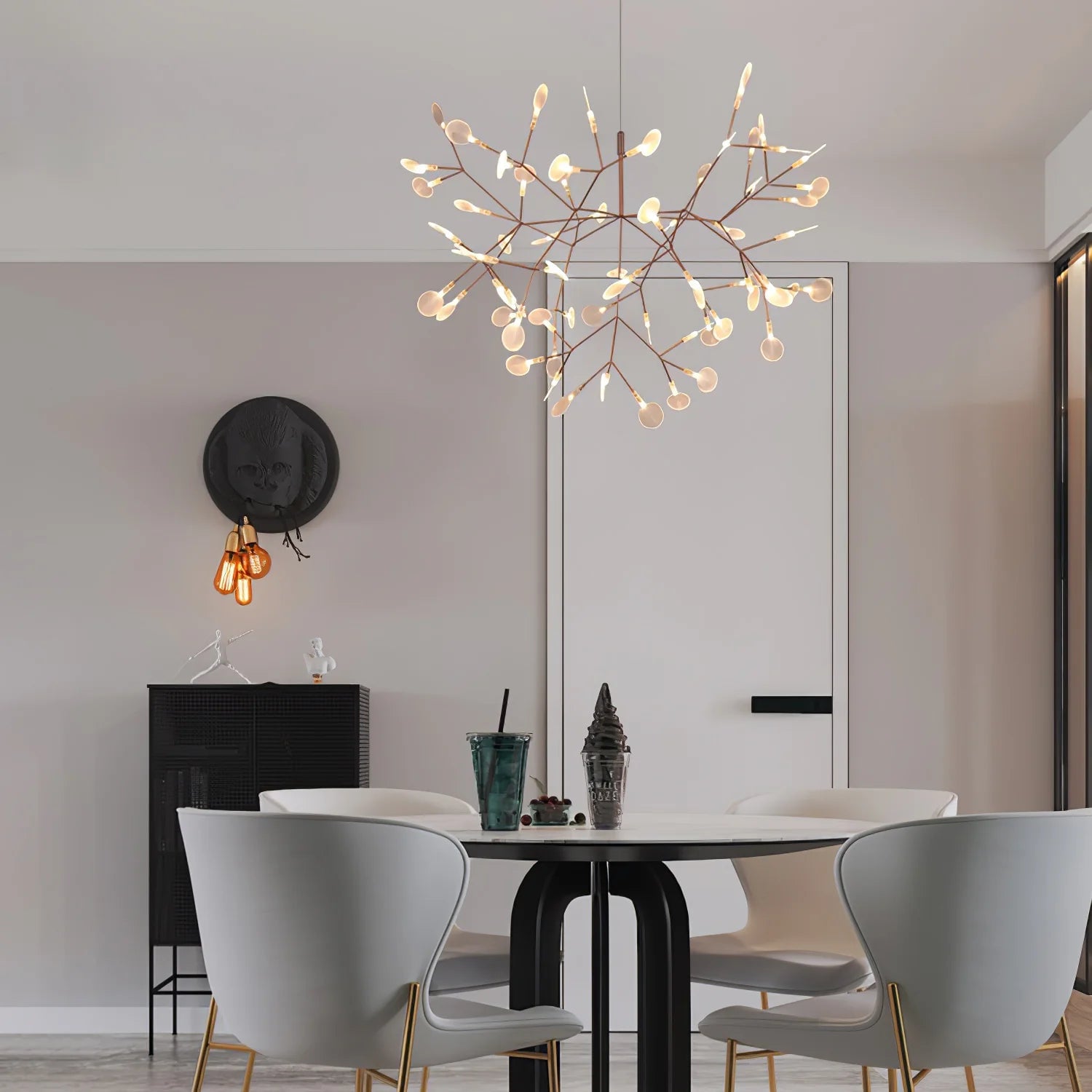 Rounded rose-colour chandelier above a dining table