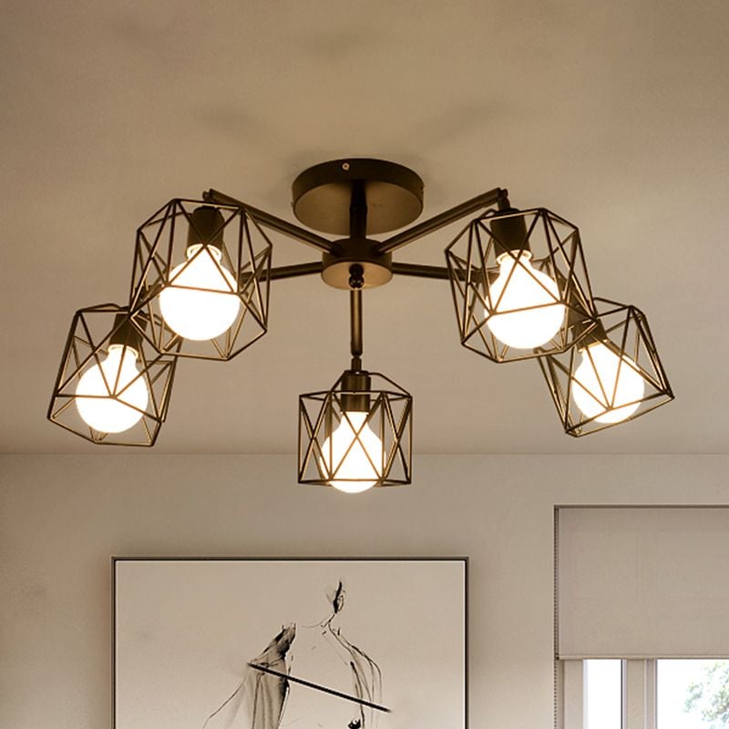 Upward view of five Herbert open cages and lit bulbs around a central hub, with a black-and-white framed picture and window shade below.