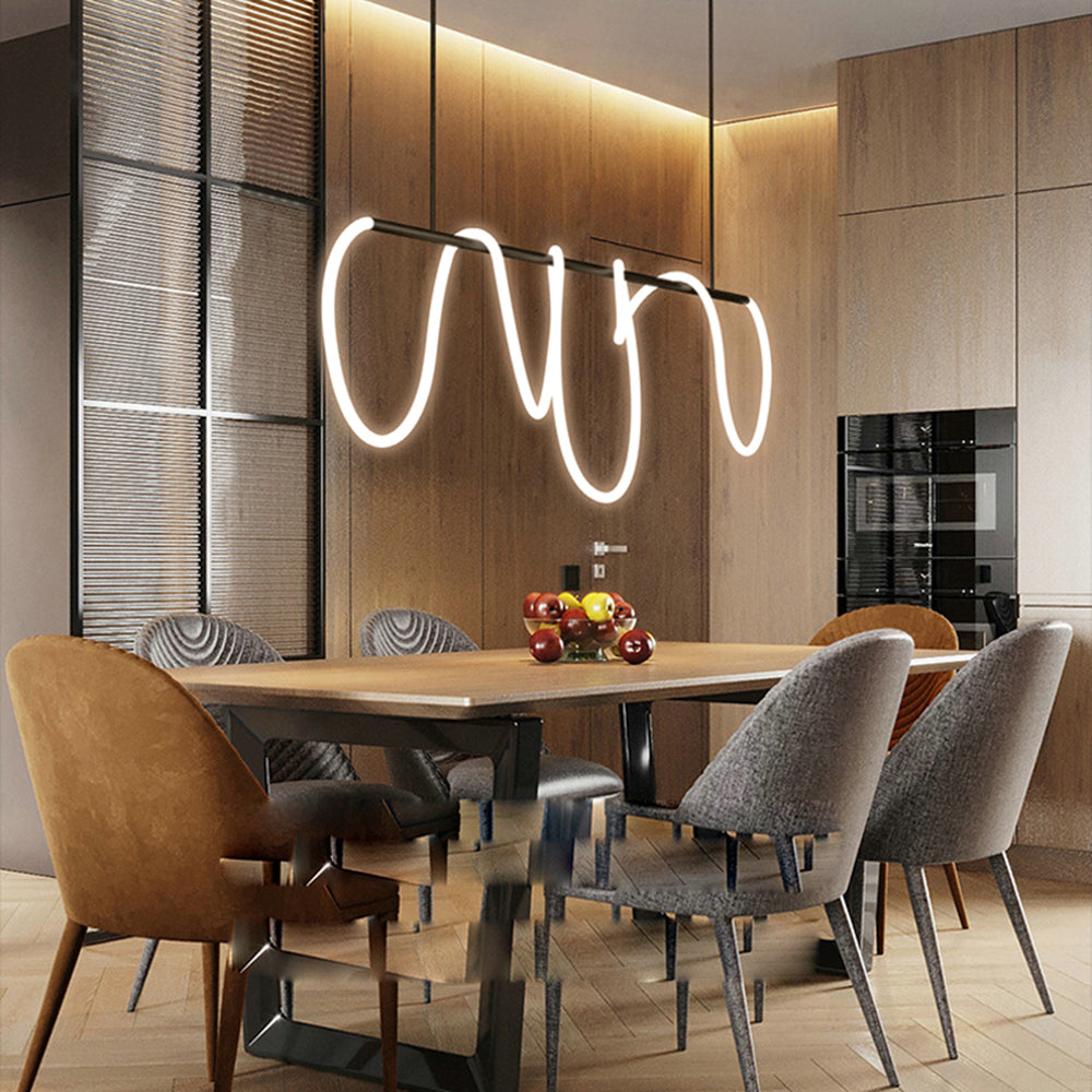 Black Louise linear light above a wood dining table, mixed gray and mustard chairs and fruit, near blinds and built-in ovens.