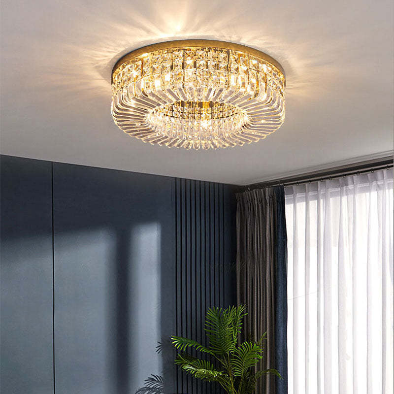 Golden Marilyn viewed from below by dark blue wall panels, a palm plant, gray curtains and white sheers.