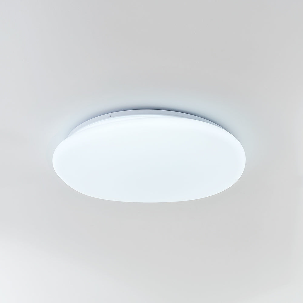 Oblique underside of Quinn pebble ceiling light showing a cool-looking luminous face and thin pale rim.