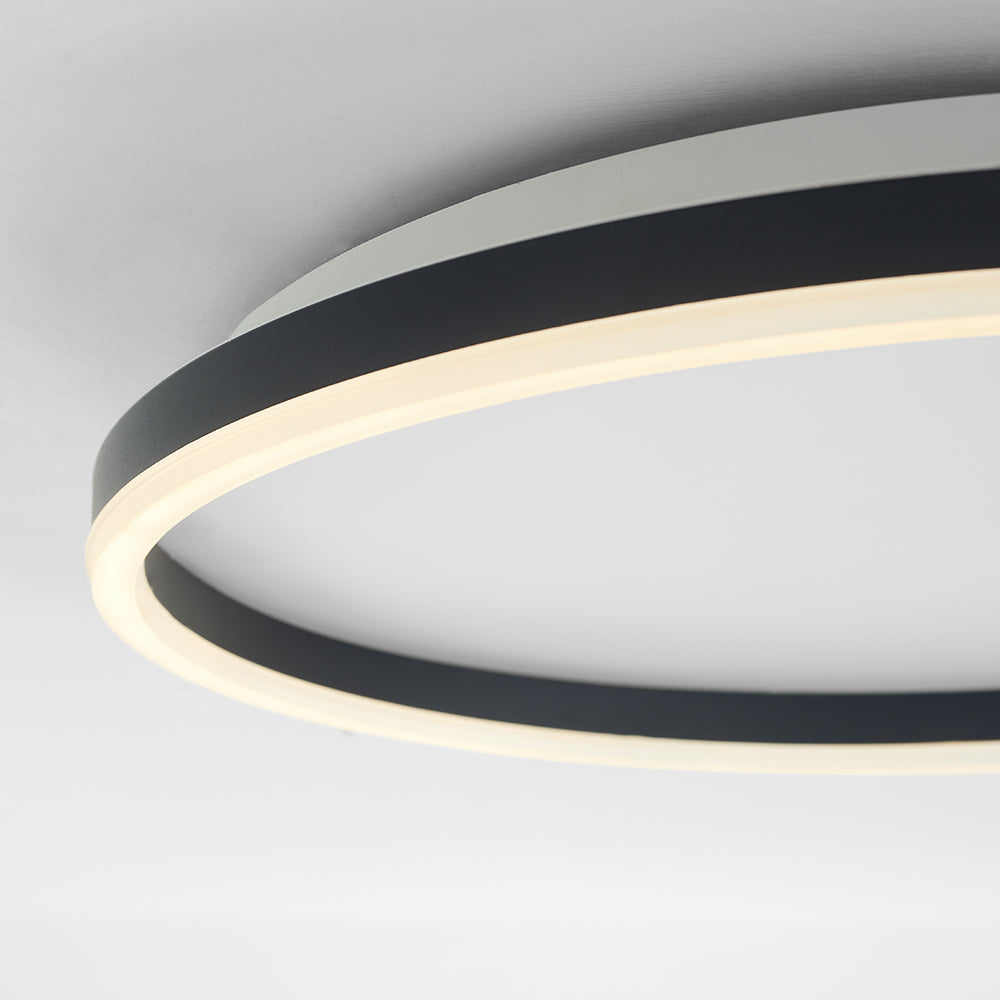 Close-up of black Arisha’s inner wall and warm-looking lower light strip, with a pale mounting plate behind.