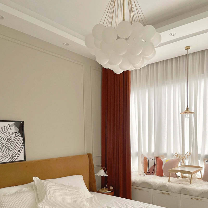 Gold globe-cluster pendant in a bedroom