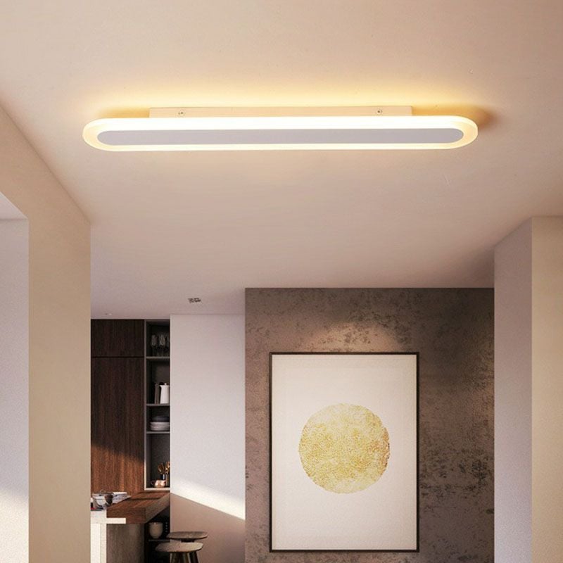 Warm glowing Edge ceiling light above a room with framed artwork