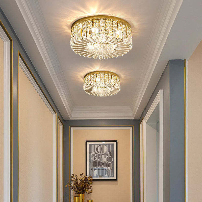 Two Golden Marilyn lights in a corridor with beige and gray walls, thin gold trim, white cornices and framed black-and-white artwork.