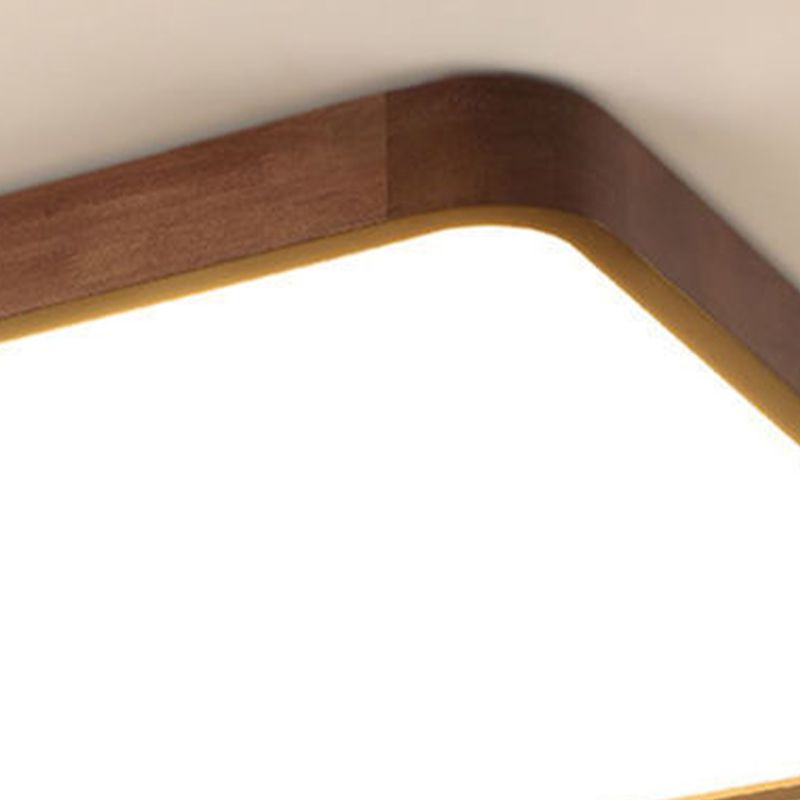 Close-up of an Ozawa wood-grain frame corner and joint beside the illuminated pale acrylic face.