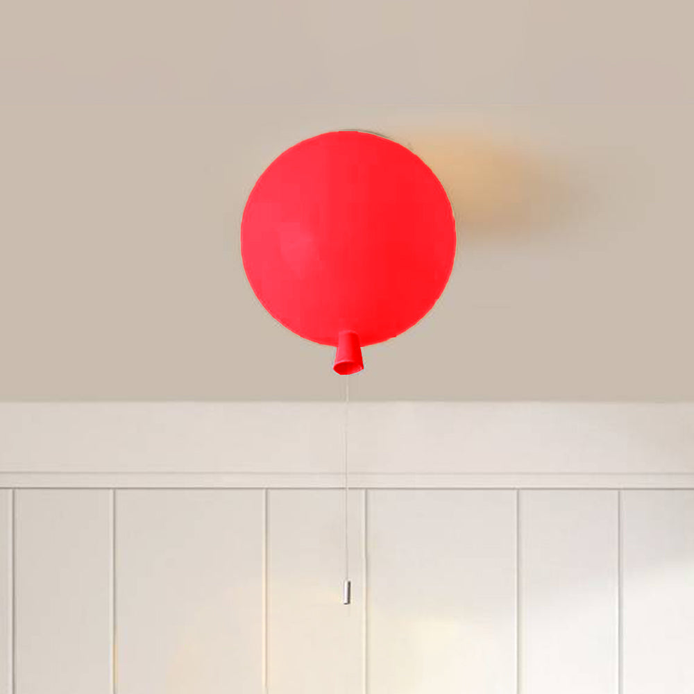 Red Fateh balloon fitting above white vertical wall panels, with a tapered lower detail, fine hanging string and pale end piece.