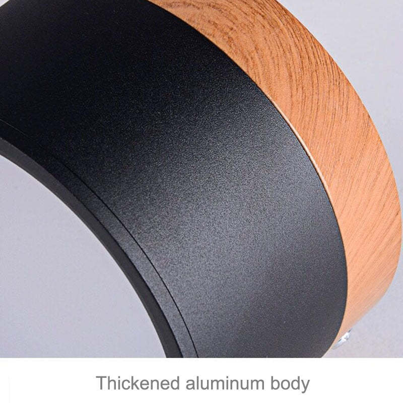 Close-up of black Morandi housing and wood-look band with supplier caption identifying an aluminum body.