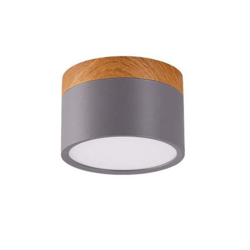 Unlabeled gray Morandi cylinder on white backdrop with wood-look upper band and pale round diffuser.