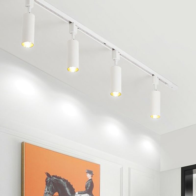 White Freja four-head track above an orange horse-and-rider artwork, with gold-tone inner reflectors and light pools on the wall.