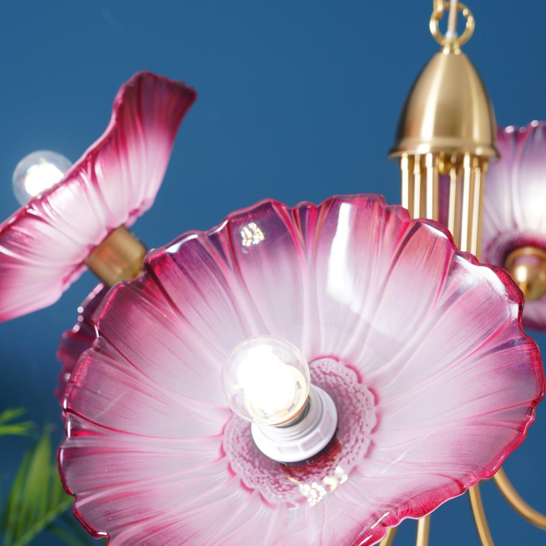 Pink ribbed glass flower and exposed bulb close-up