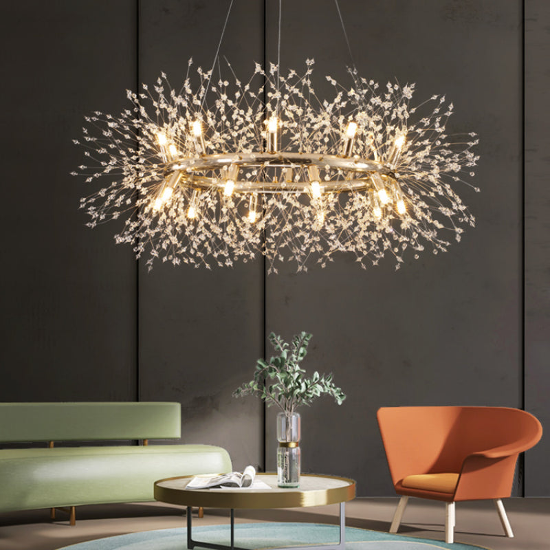 Lili crystal ring above a round coffee table between a pale green sofa and orange chair, against a dark paneled wall.