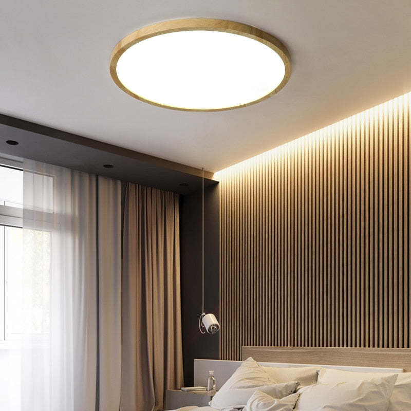 Illuminated Ozawa round ceiling light beside a wood-slat wall