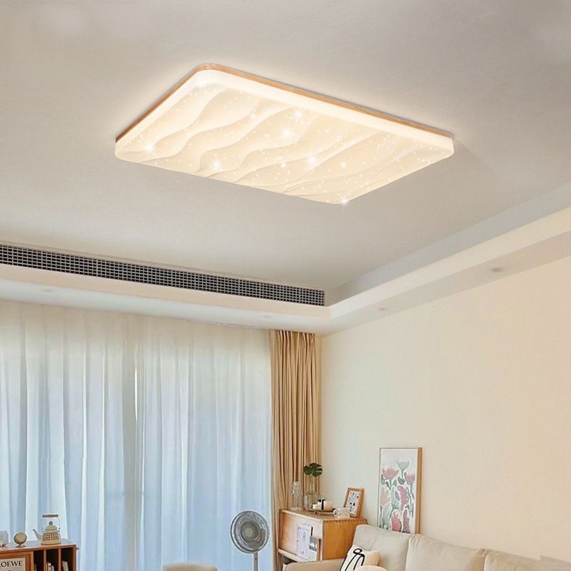 Rectangular Ozawa light with a bright rippled face above a pale sofa, botanical painting and wood cabinet beside a standing fan and curtains.