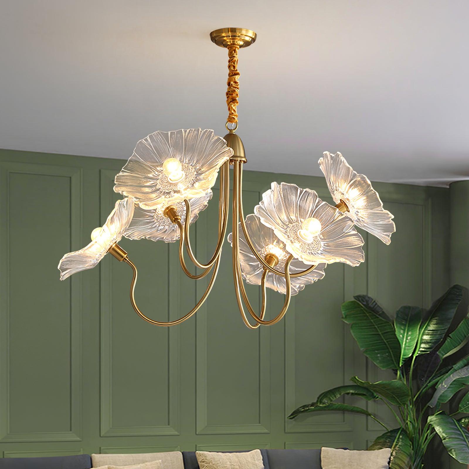 Illuminated clear flower chandelier near green wall