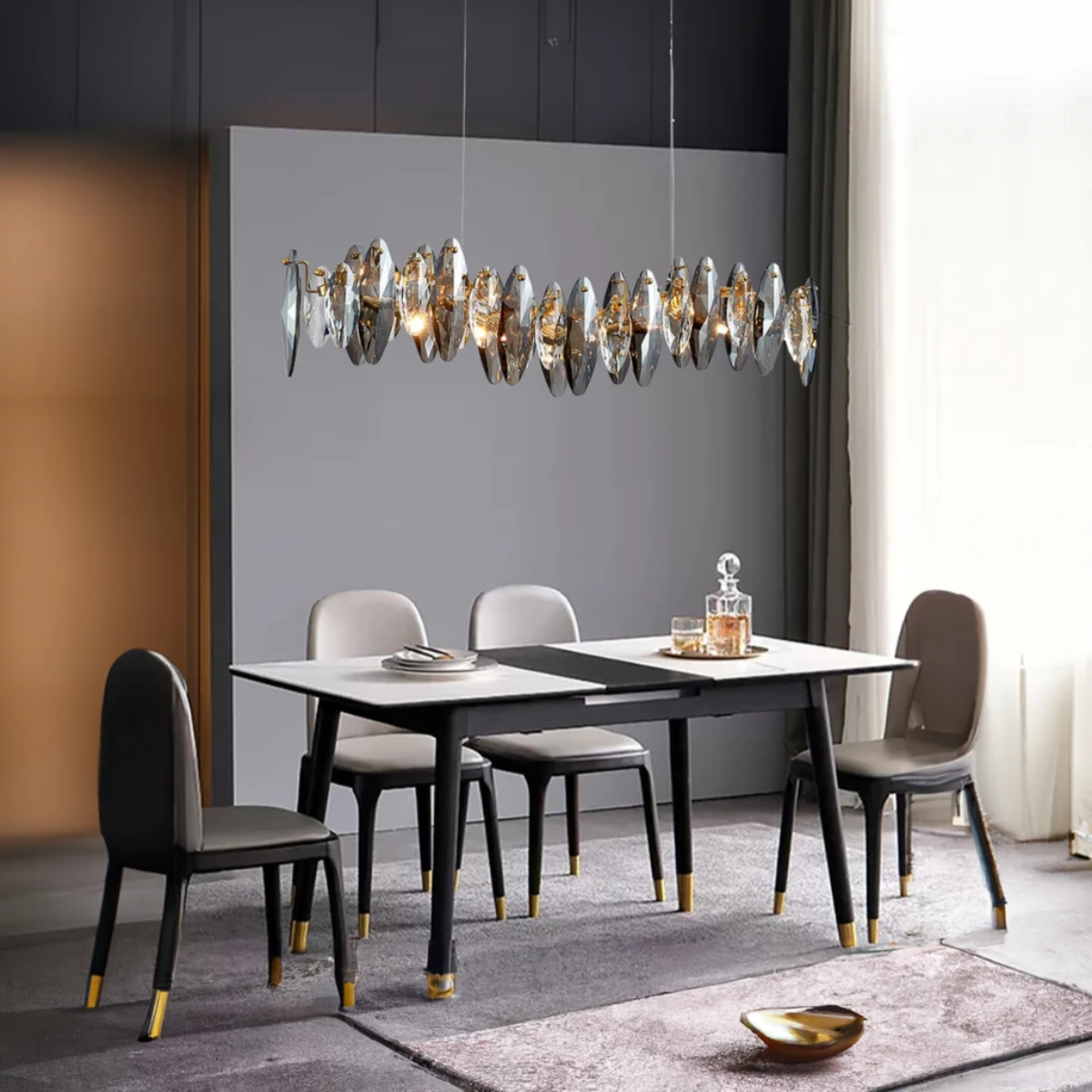 Olivia oval-glass-disc pendant glowing above a round dining table and upholstered chairs.