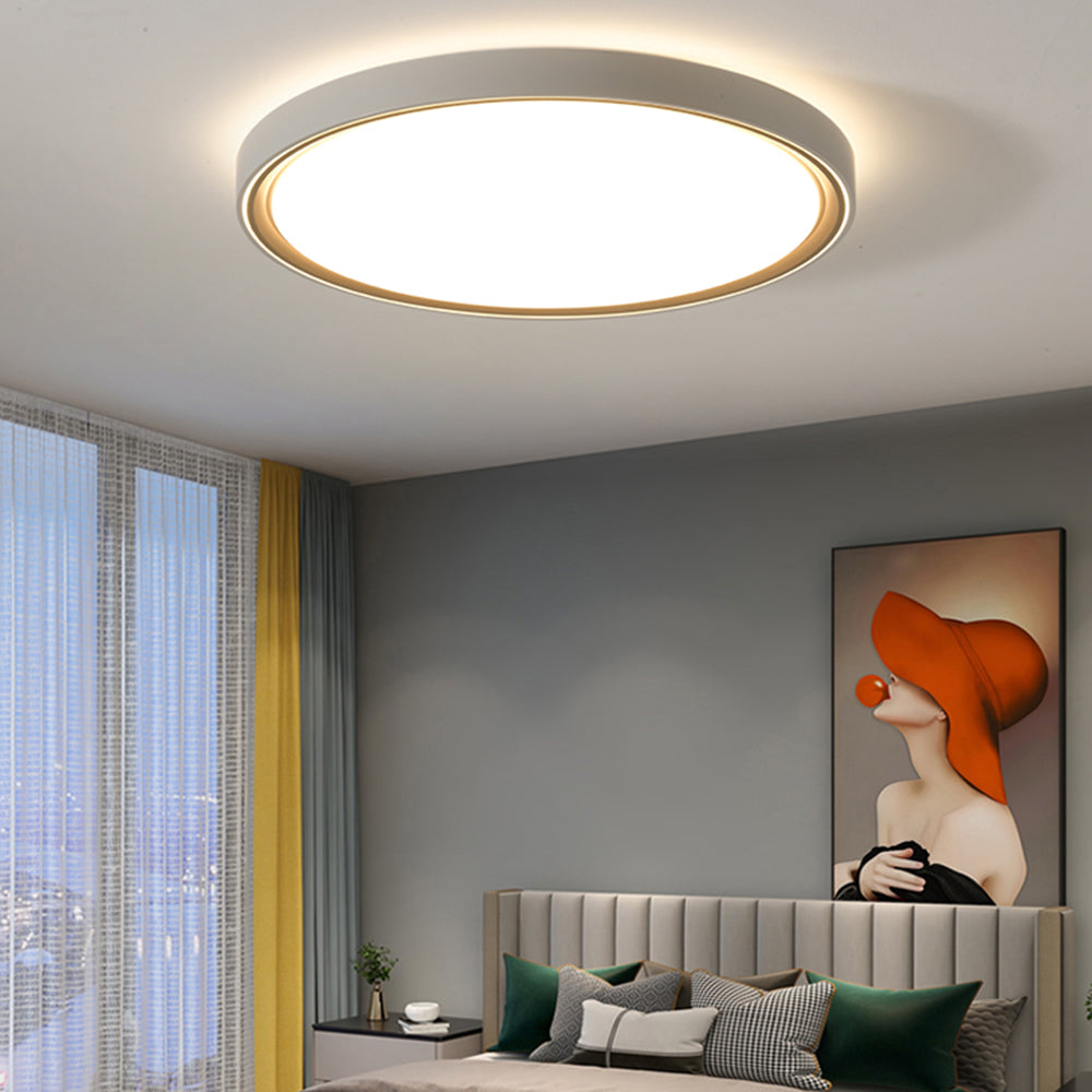 Round Quinn above a fluted headboard with green cushions, grey wall, yellow curtain accent and an orange-hat portrait.