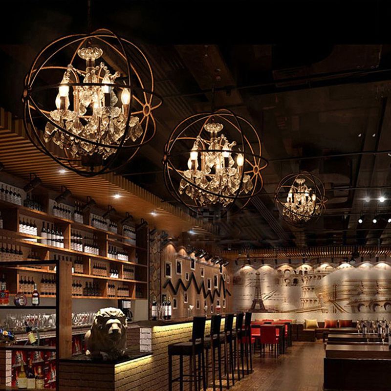 Several illuminated Kristy spherical cage pendants above a bar counter.