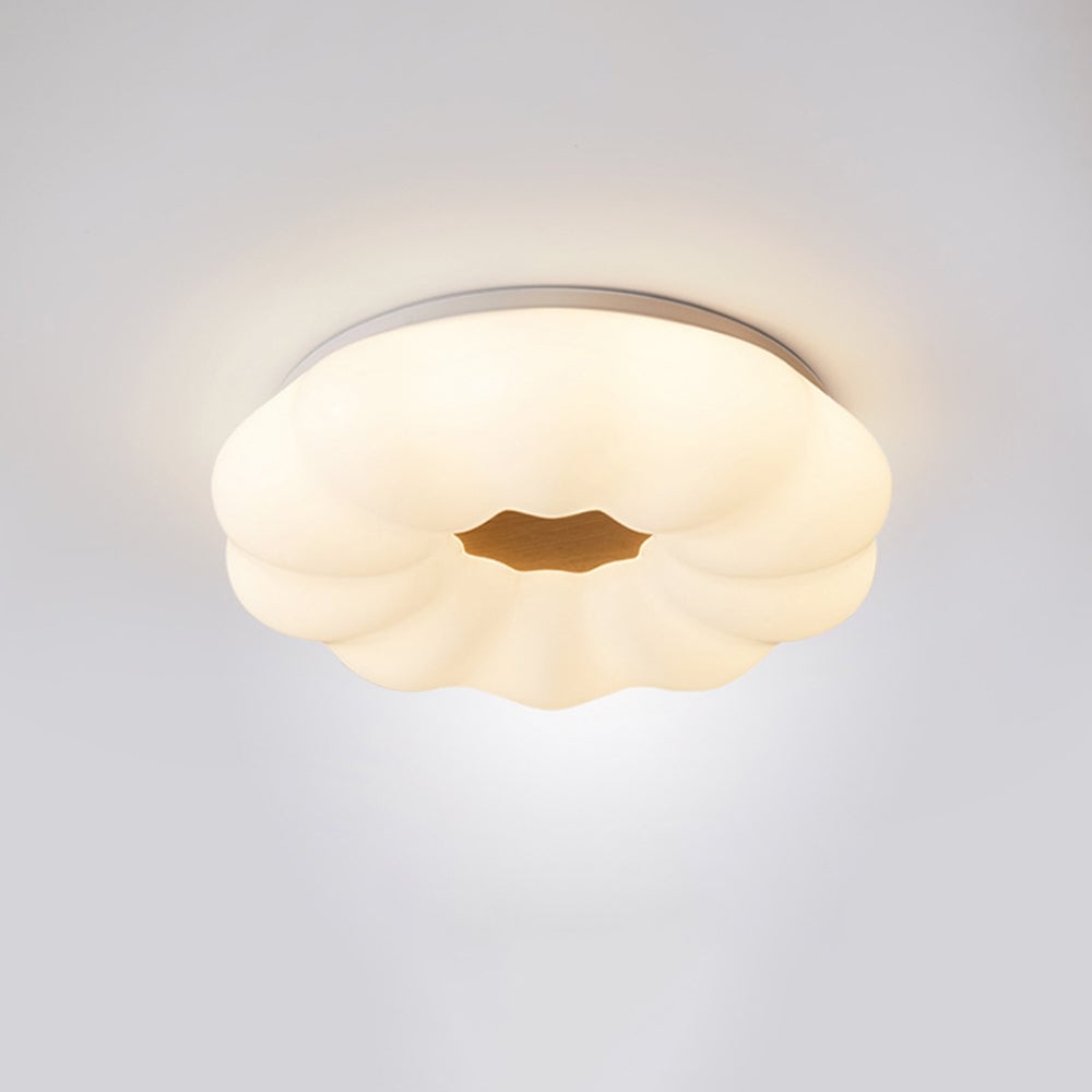 Ozawa flower-shaped light shown illuminated against a plain ceiling.