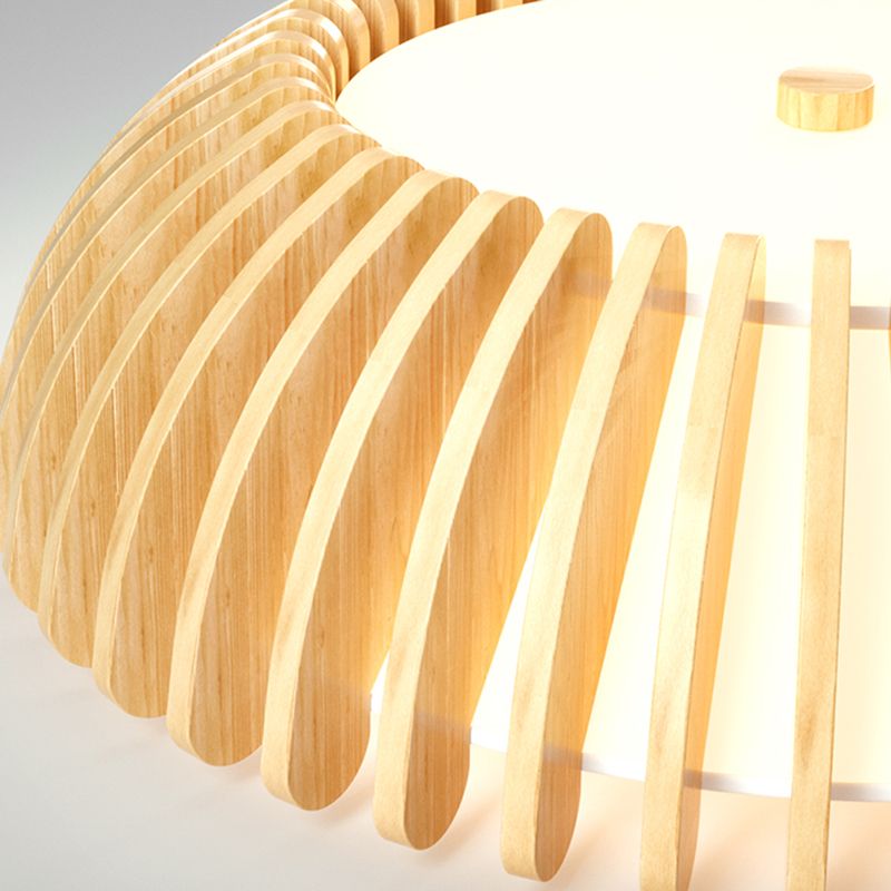 Close view of lit Ozawa with light between curved wood-grain slats, a bright lower face and central wood-tone cap.