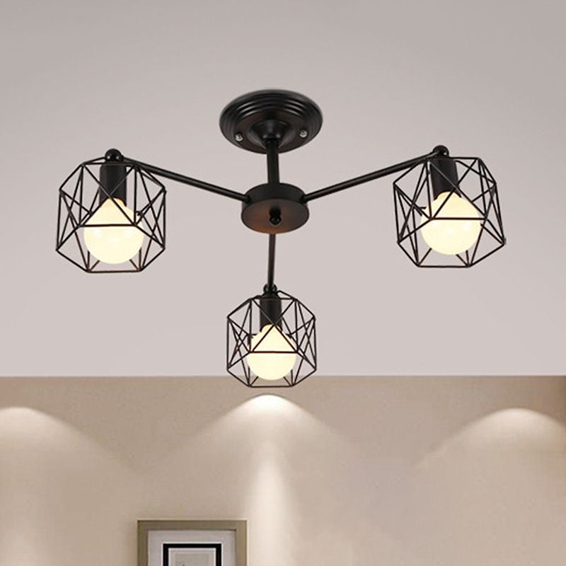 Three black Herbert cage shades and lit bulbs beneath a round grooved ceiling canopy, above a pale wall and the top of a picture frame.