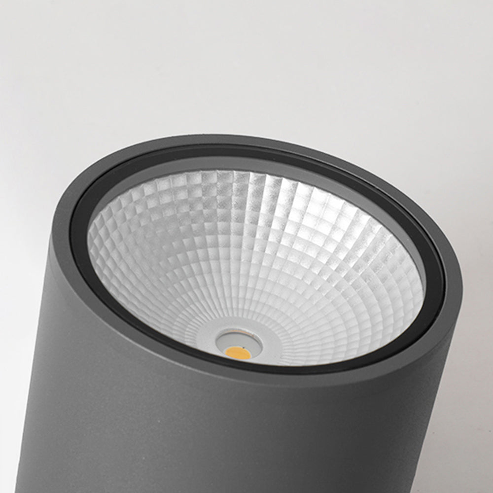 Orr close-up of a black circular rim and faceted reflector with a small pale centre and yellow circular detail.