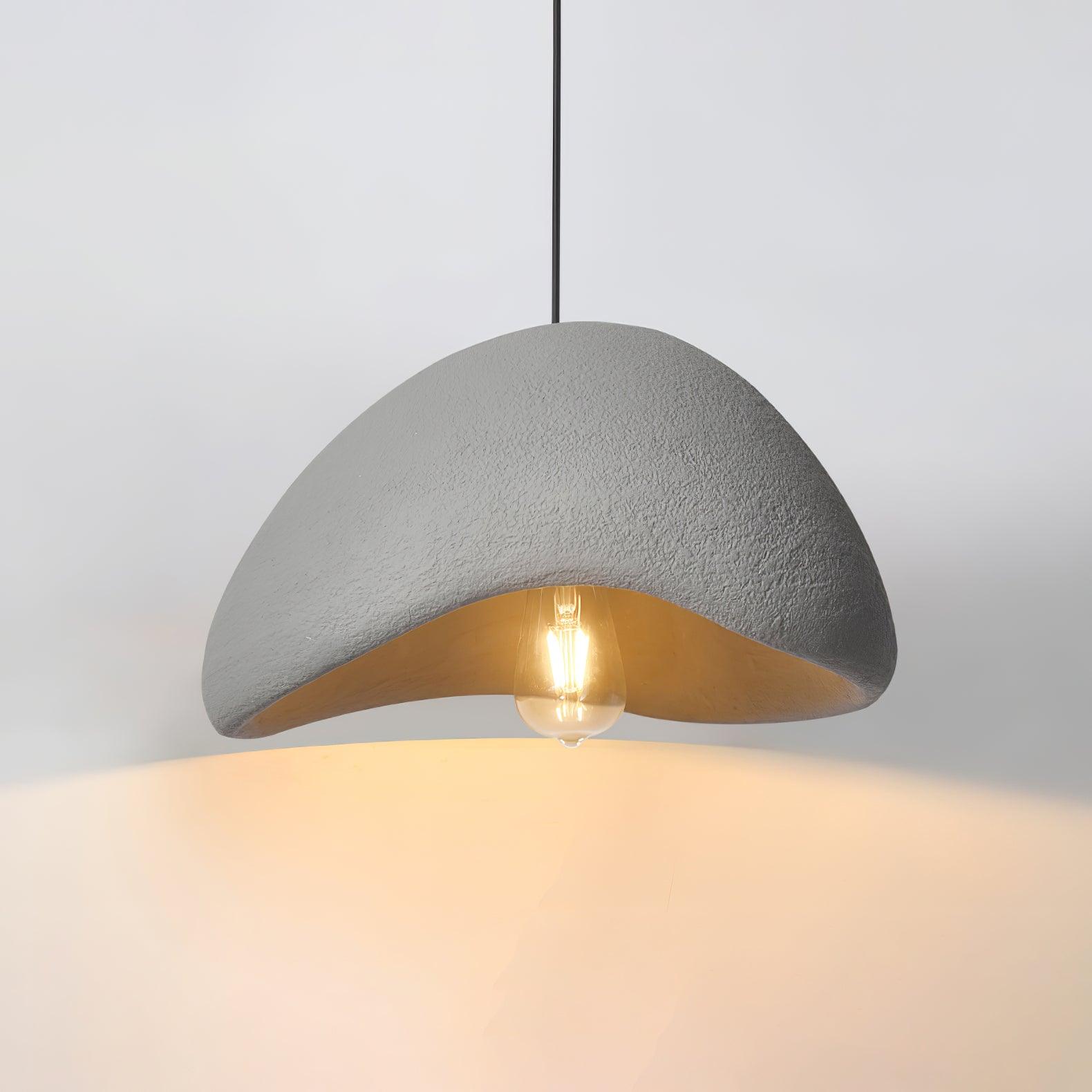 Gray speckled cloud-shaped pendant with an elongated glowing bulb and black suspension cord on a pale background