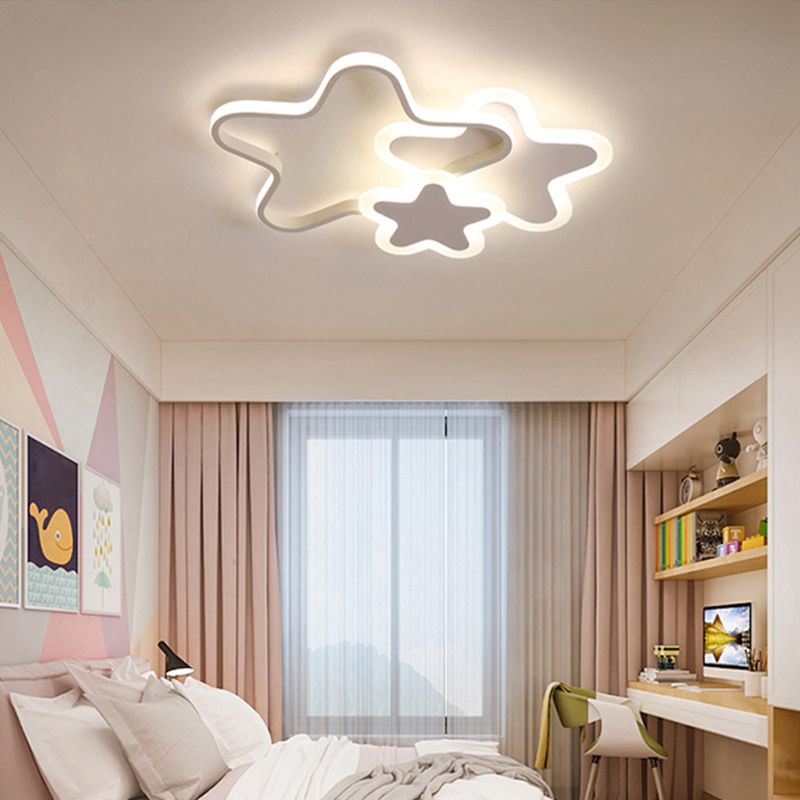 White star-shaped Morandi ceiling light in a bedroom beside a bright window.