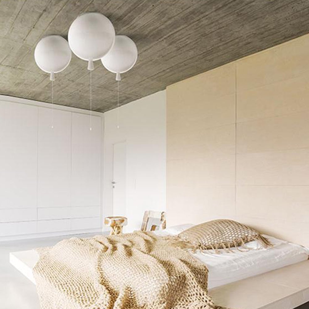 Three white Fateh balloon fittings above a pale bed, checked bedding, wardrobe doors and a wood-patterned ceiling.