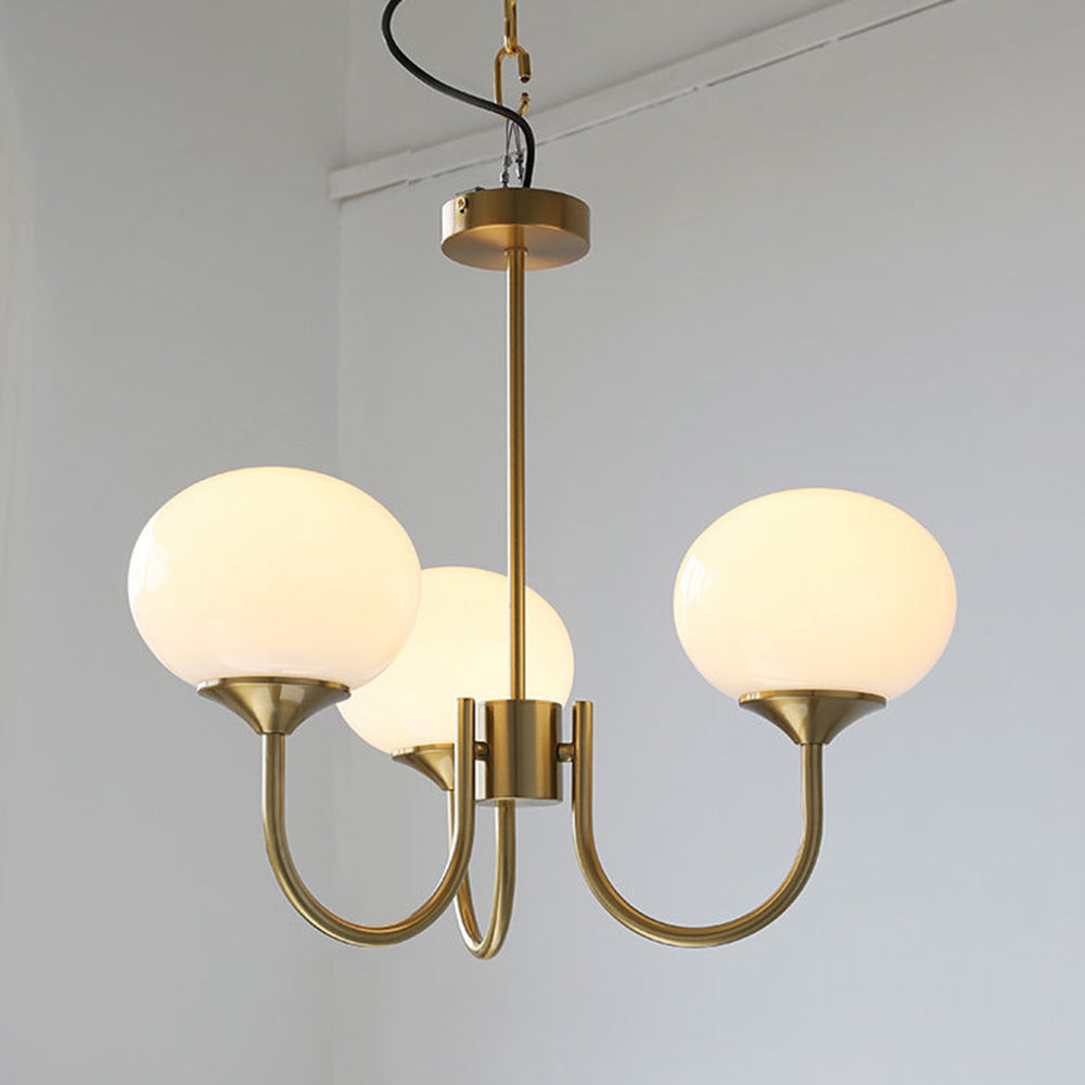 Illuminated white three-globe chandelier with curved arms
