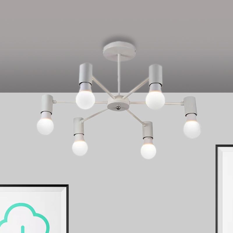 Close view of white six-light fixture with radial arms, exposed bulbs and round hub above framed cloud artwork