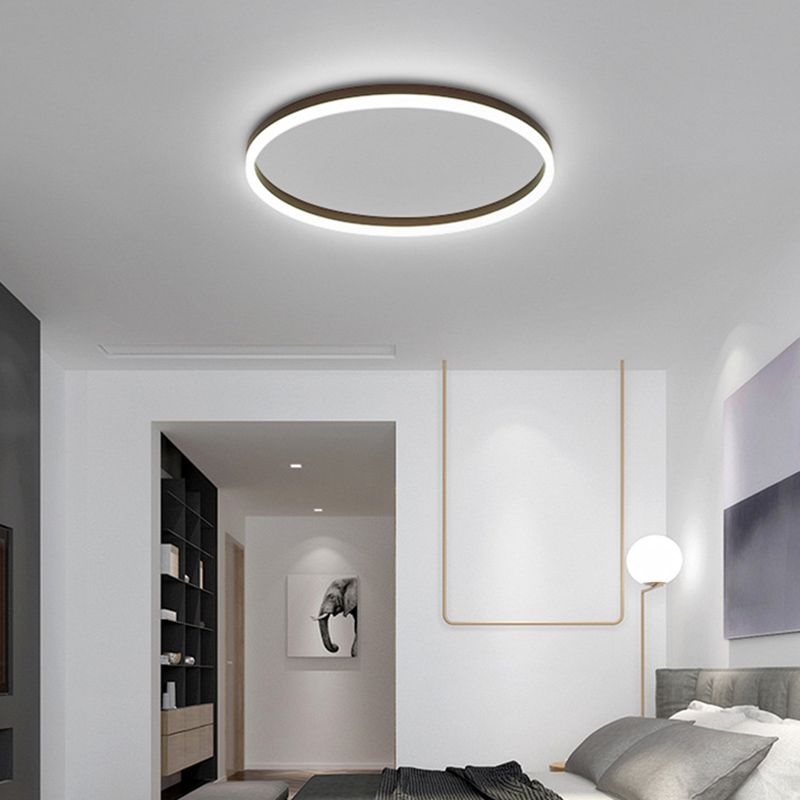 Black Quinn ring ceiling light in a modern bedroom with pale walls.