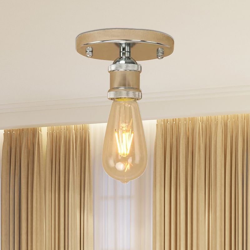 Pale metallic Alessio canopy and holder with silver-looking collar accents above an exposed elongated bulb and golden curtains.