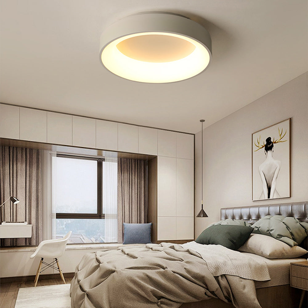 White Quinn ceiling light over grey upholstered bed and green pillows, with white cabinets, curtains and separate bedside pendant.
