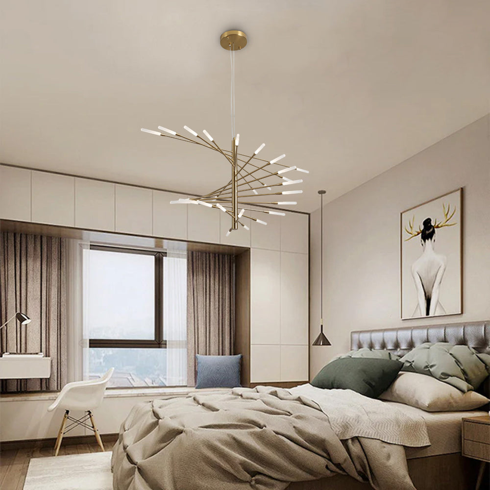 Gold Lowry chandelier in bedroom with gray tufted headboard, beige bedding, framed figure and separate bedside pendant