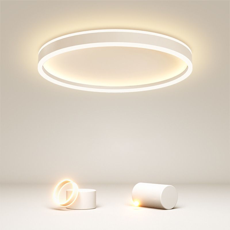 White Quinn circular ceiling light above a cabinet and decorative objects