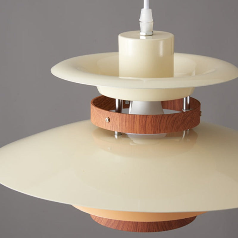 Close view of white upper cup and layered plates, wood-grain ring with screws, metal supports and visible bulb holder
