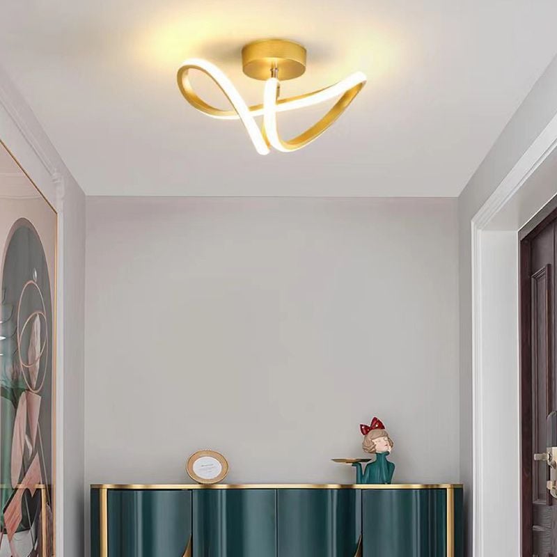 Gold Lacey loop ceiling light over a room with a teal cabinet