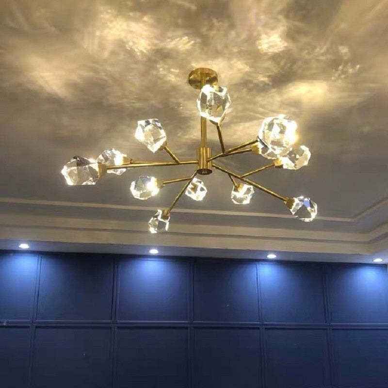 Lit Kristy viewed from below with patterned ceiling reflections, blue wall panels and separate recessed downlights.