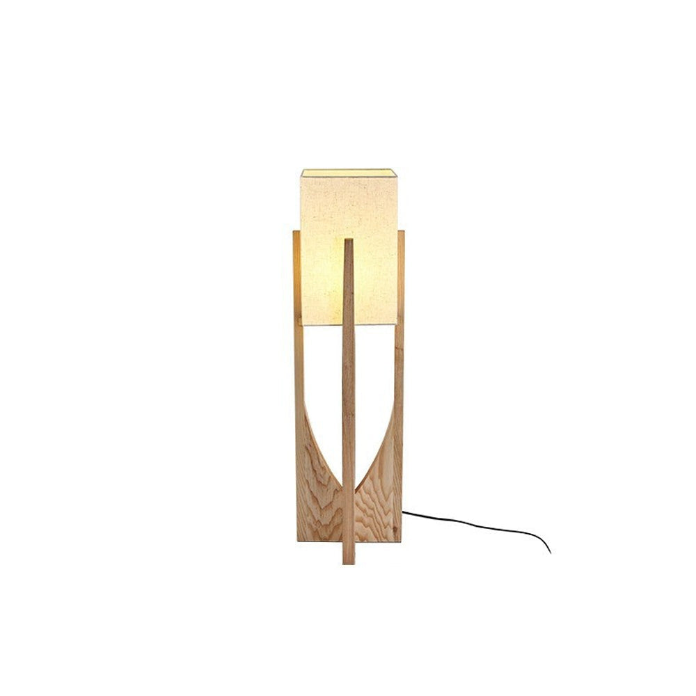 Isolated shorter light wood-tone Ozawa lamp, cream rectangular shade, grained wooden panels with curved cutouts and black cord