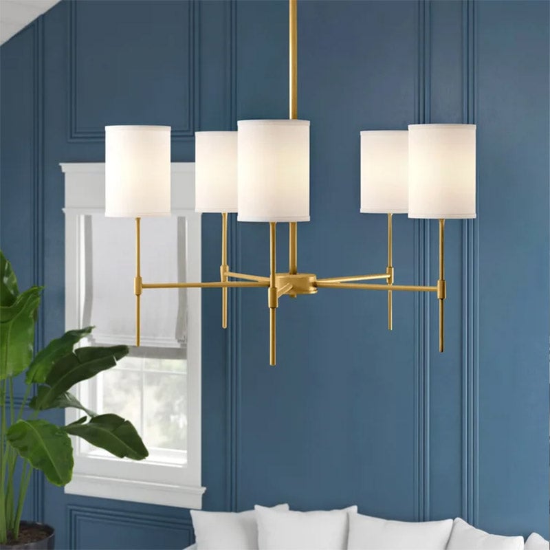 Gold Silva chandelier with illuminated white drum shades