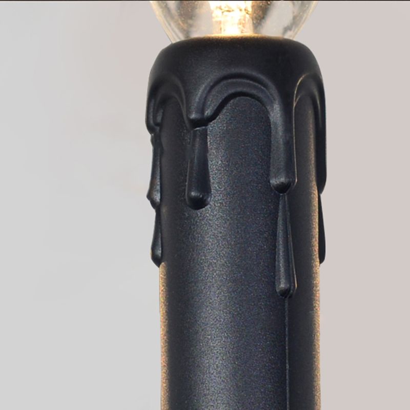 Close-up of Black Silva candle-style bulb holder with decorative wax-drip relief and glass bulb above