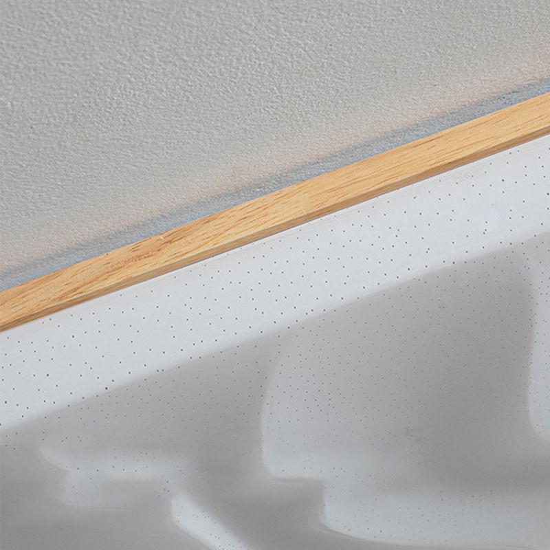 Tight detail of the Ozawa wood-tone upper rim and small dot markings beside raised ripples in the white face.