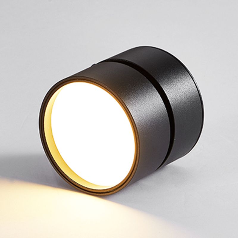 Loose black Novak fixture on grey, showing a broad glowing circular face and gap between the head and base.